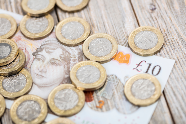 A decorative image of cash on a table