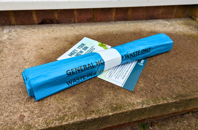 A roll of 20 blue bin bags and a leaflet on the doorstep