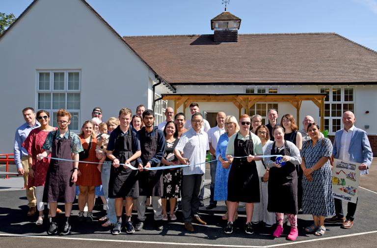 Representatives from the school, the council and the contractors cut a ribbon in front of the school