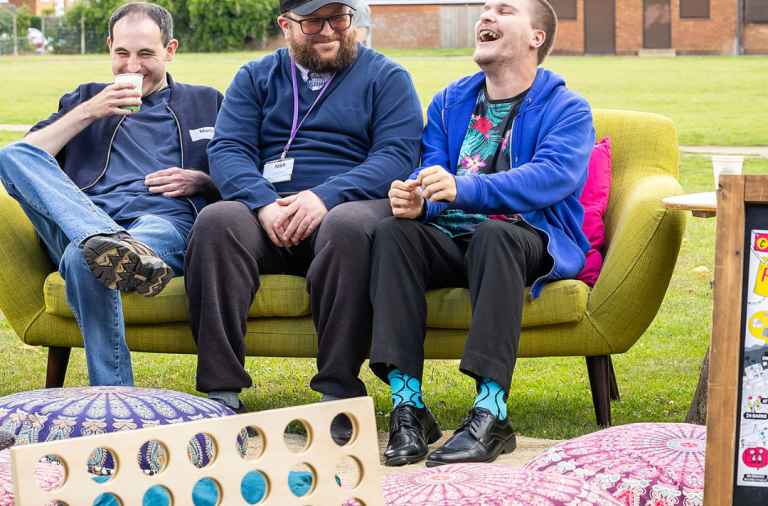 A few Wokingham residents socially sitting on a green