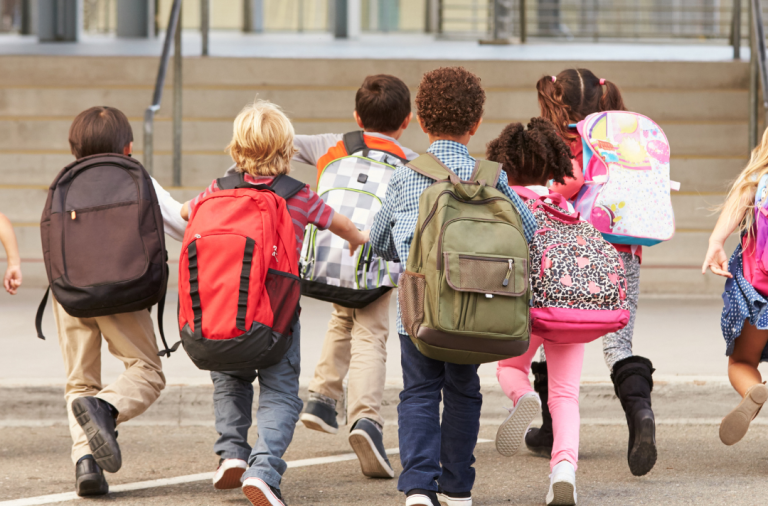 Group of young school children with backpacks