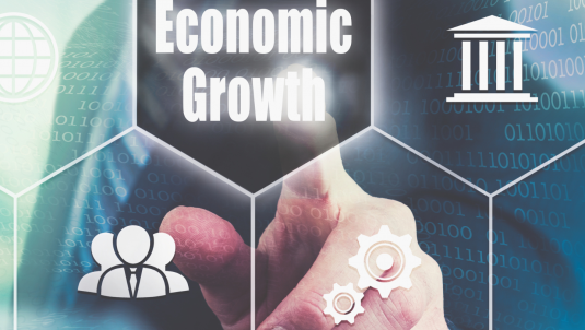 A conceptual image: a man in the background with a finger pointing to the text that reads Economic Growth