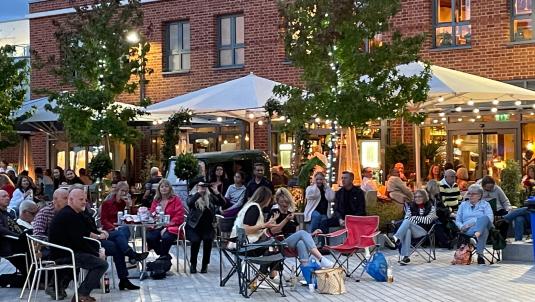 People sitting out in an outdoor space 