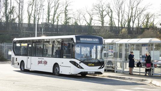 A bus pulls up to collect people at Winnersh Triangle park and ride